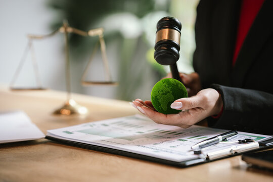 Judge's gavel above a green globe symbolizing environmental law, ESG compliance, climate justice, and sustainable governance.