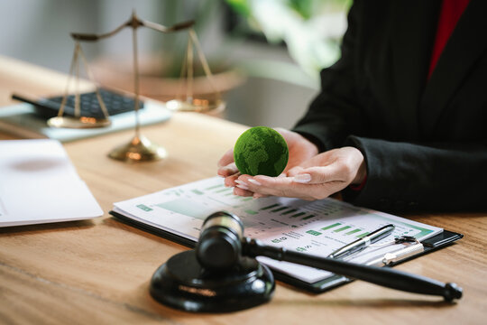 Judge's gavel above a green globe symbolizing environmental law, ESG compliance, climate justice, and sustainable governance.