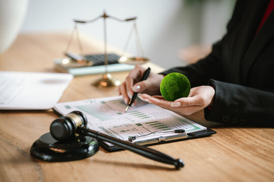 Judge's gavel above a green globe symbolizing environmental law, ESG compliance, climate justice, and sustainable governance.