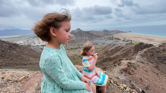 Children play the harmonica on the mountain trail