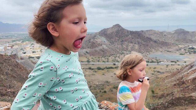 Children play the harmonica on the mountain trail