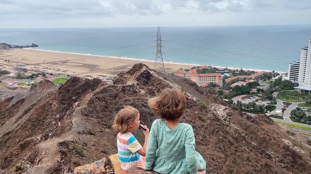 Children play the harmonica on the mountain trail
