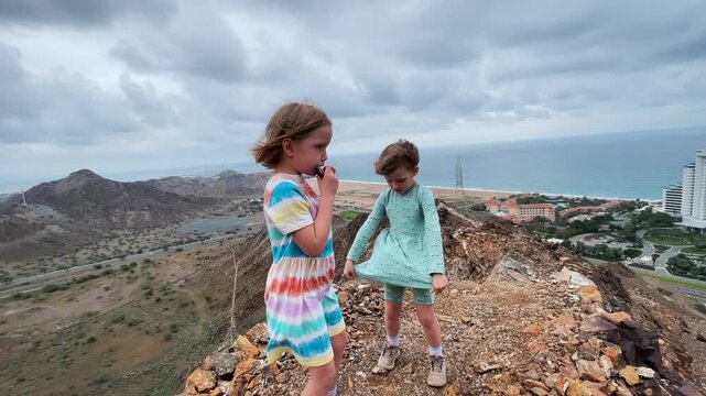 Children play the harmonica on the mountain trail