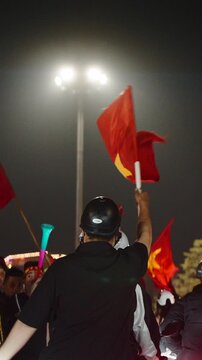 Vietnamese soccer fans celebrating a victory at night