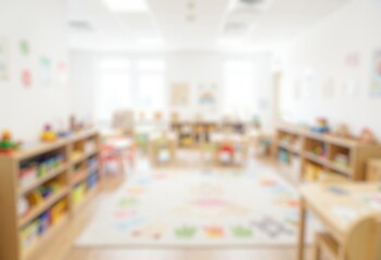 Fototapeta premium Blurred kindergarten classroom with colorful furniture, perfect for education and childhood backgrounds.