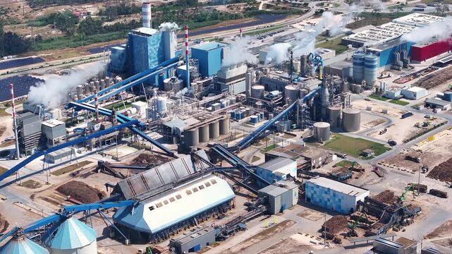 Aerial view of industrial paper mill plant with smoking chimneys