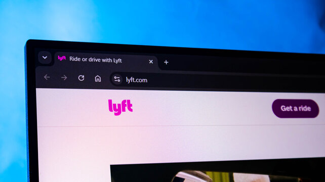 Lyft website and logo on a modern laptop computer screen. lyft is an American ride-sharing company.