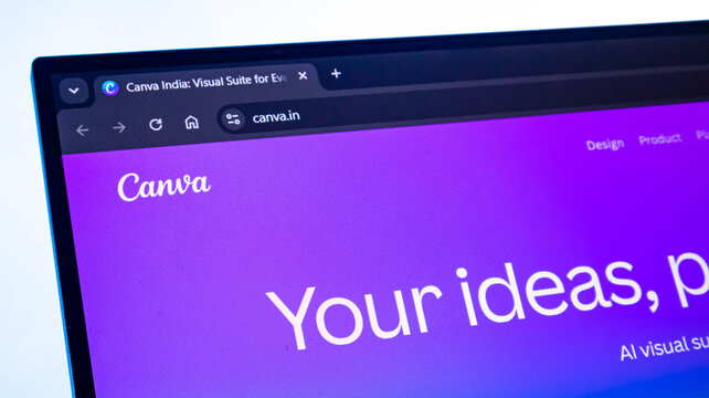 Close up view of canva.in homepage on a laptop screen displaying company's logo and website address.