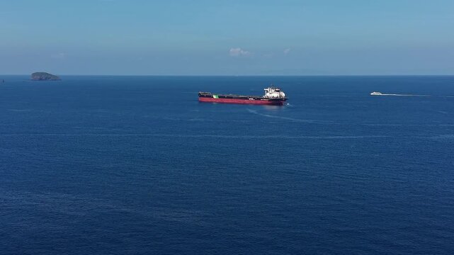 Candidasa, Bali, Indonesia - July 15 2026: Drone Approaching NYK LNG Tanker Ship Sailing Bali Strait.