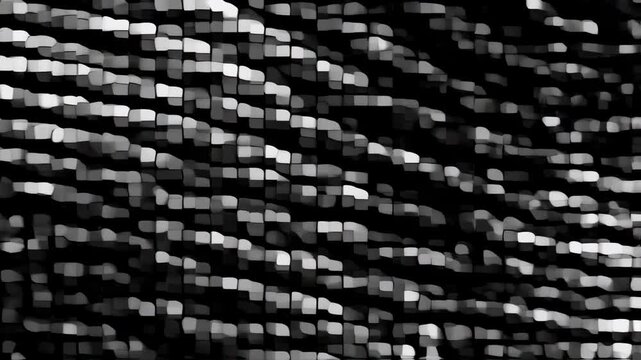 A grayscale, abstract artwork featuring a mosaic-like pattern of irregular blocks. Soft tones create depth