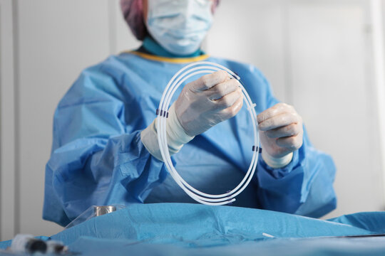 Removal of blood clots through small holes. The surgeon's hands. Surgical interventions on blood vessels. Vascular endovascular surgery. The concept of healthcare.
