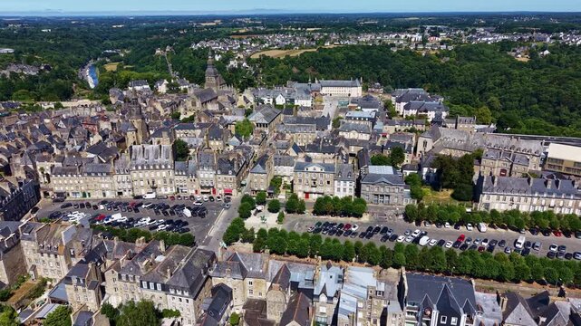 Place Du Guesclin, Saint-Sauveur Basilica, Clock Tower, Dinan Viaduct and the Rance River in Dinan, Cotes-d'Armor, Brittany, France, revealing the medieval fortified town, drone pullback.