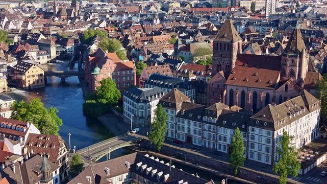 Saint Thomas church and historic city center, Strasbourg in France. Aerial drone sideways and cityscape
