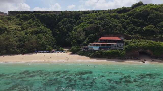 Aerial View of Gunung Payung Beach with Turquoise Water and Cliff in Bali