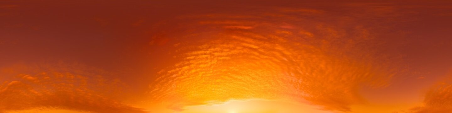 Sunset clouds panorama view of a vibrant fiery sky at dusk with copy space for creative designs
