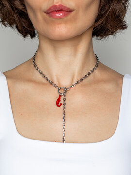 Modern pearl and steel chain jewelry on young woman - contemporary fashion accessory portrait with natural makeup