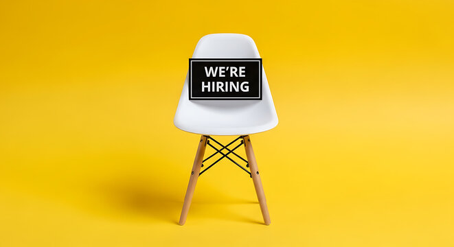 Empty chair with 'We Prep Hiring' sign for recruitment concept. Minimalist office setup ready for job interview or candidate selection.