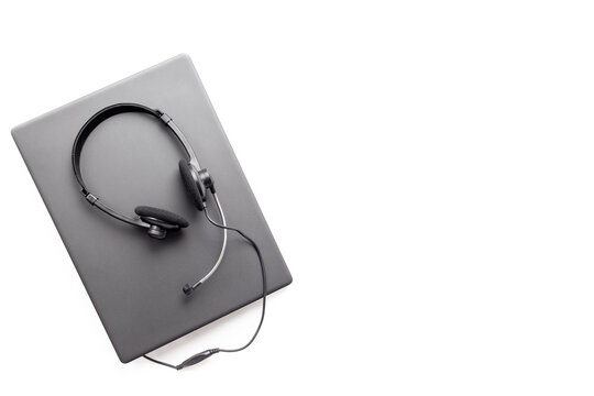 Modern call center desk setup with laptop and headset - online customer service and remote work concept