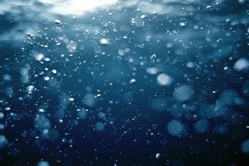 Naklejka premium The Underwater Bubbles in Deep Blue Ocean Creating Dreamy Light Particles