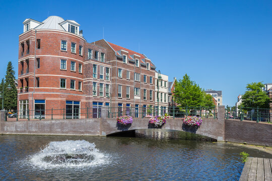 Fountain and bridge with pink flowers in Bussum, Netherlands
