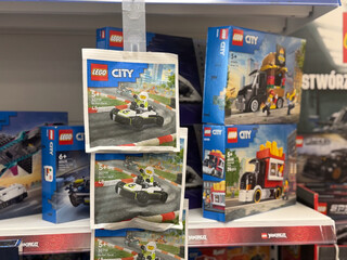 Obraz premium Toy building set boxes and hanging cards displayed on a store shelf in a retail aisle