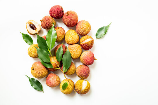 Exotic lychee fruit with green leaves, top view. Healthy vegetarian meal