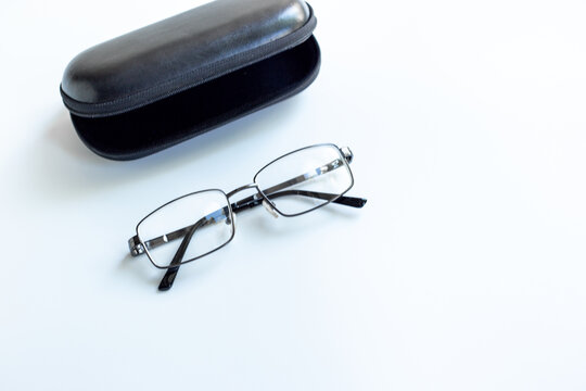 Stylish glasses for vision with case on white background. Eyesight and vision concept.