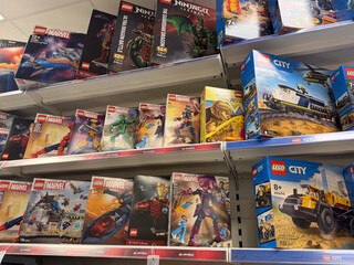Fototapeta premium Shelves of lego toy boxes in a retail store aisle