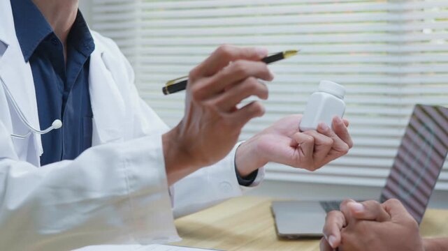 Doctor explaining treatment and medication instructions to a patient during a medical consultation in a clinic office, representing patient care, prescription guidance, healthcare service and treatmen