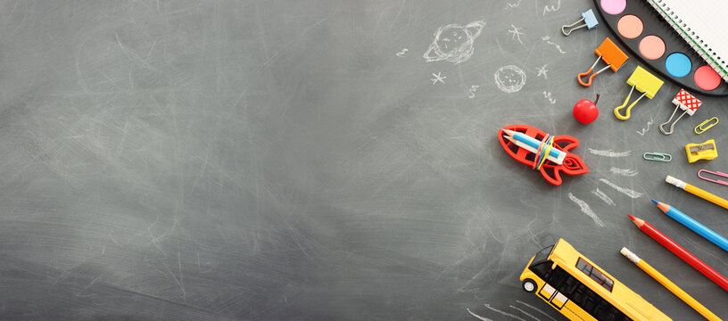 Back to school concept over classroom blackboard. Top view
