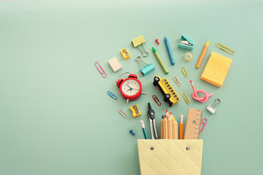Back to school concept over pastel background. Top view