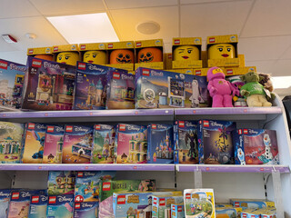 Obraz premium Assorted lego toy boxes and plush figures displayed on a store shelf in a toy shop