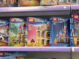 Fototapeta premium Colorful lego disney princess toy boxes displayed on a retail store shelf