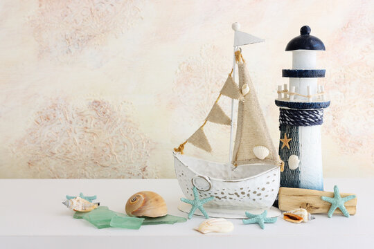 summer background with boat, blue sea glass and shells