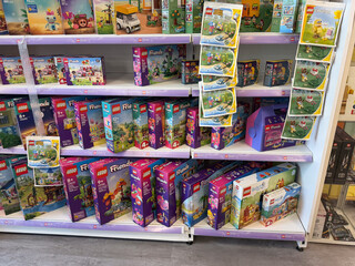 Fototapeta premium Retail store shelf filled with colorful lego friends toy boxes on display