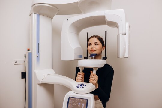 Woman undergoing dental panoramic x-ray examination