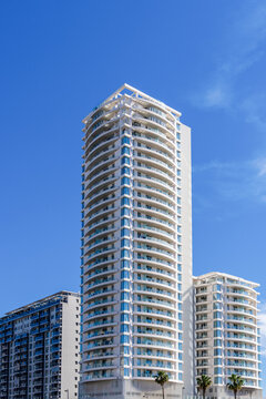 tall modern buildings in white and blue in a big city
