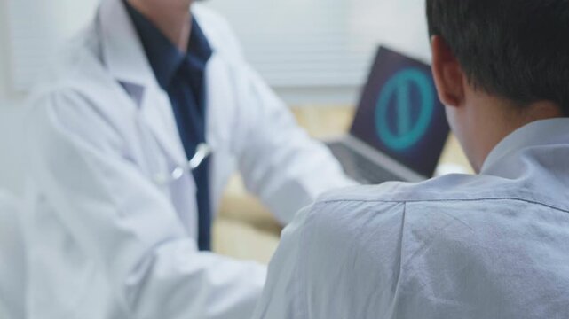Doctor gently patting a patient on the shoulder to offer comfort, reassurance and emotional support during a medical consultation in a clinic, representing compassionate healthcare, trust and patient-