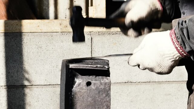 This process involves a technician utilizing a hammer to shape metal on an anvil, followed by the systematic arrangement of finished iron plates in a workshop, ensuring precision and uniformity.