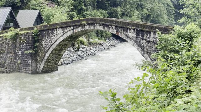old stone bridge with a river