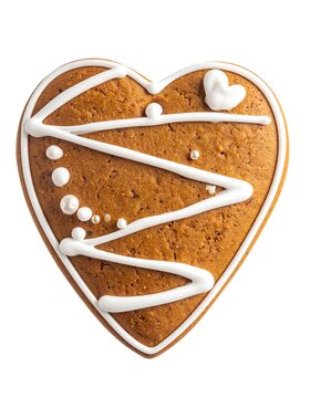 A heart-shaped gingerbread cookie with white icing and decorative dots