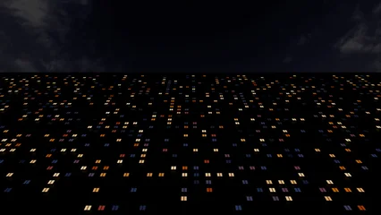 Facade of a multi-storey building with illuminated windows at night as a pixelated abstraction. © sv_production