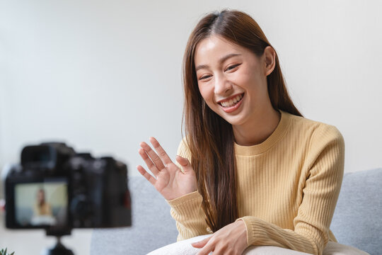Young asian woman recording herself interview video via smartphone for her vlog.