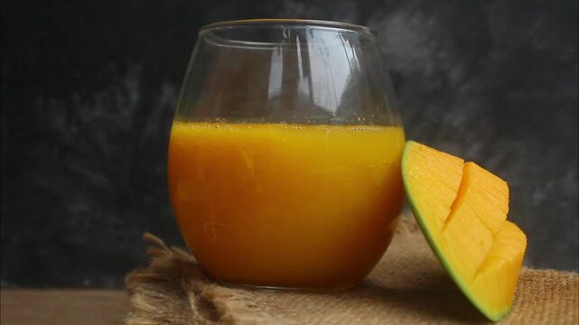 flat lay of a glass of mango juice on a table