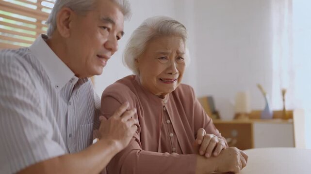 Health insurance with caregiver at home senior couple elderly woman emotional support at home sadness comfort hand care tear family private difficult moment with man consoling partner indoors