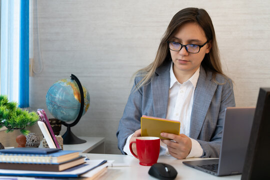 Woman checking a passport or official document at a visa center or office desk. Border control, office routine, and daily administrative work.