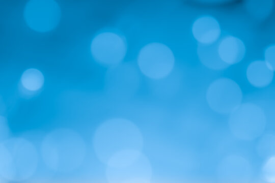 Abstract blue bokeh lights background with soft gradient and glow