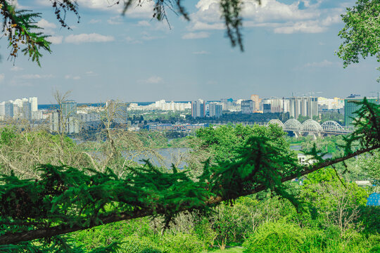Modern city skyline panorama from a park hill terrace. Scenic view of residential buildings