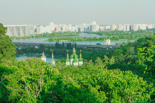 Panoramic cityscape view with old monastery, high-rise buildings on a river bank. Urban landscape