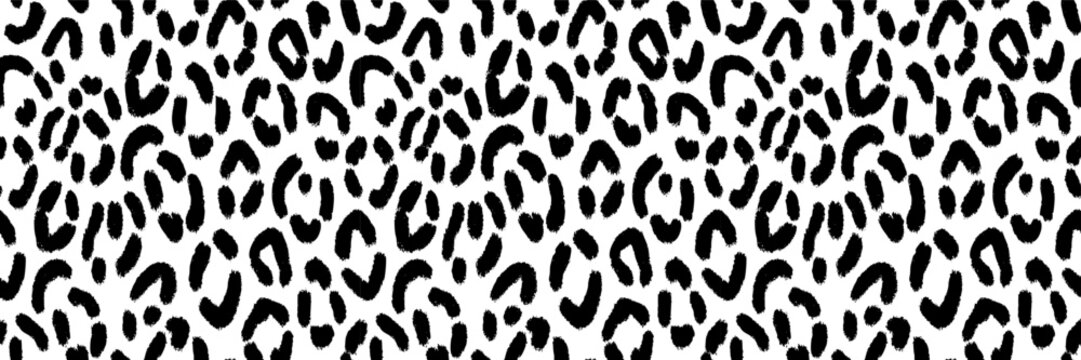 Seamless black and white leopard print vector pattern with hand drawn textured spots.